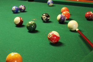 This is a picture of a pool table with colorful pool balls.