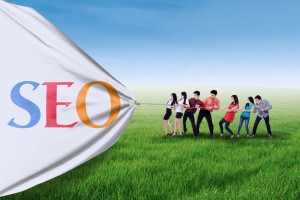 An image of people pulling a banner that reads, "SEO."