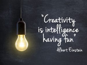 Light bulb lamp on blackboard background with creativity quote