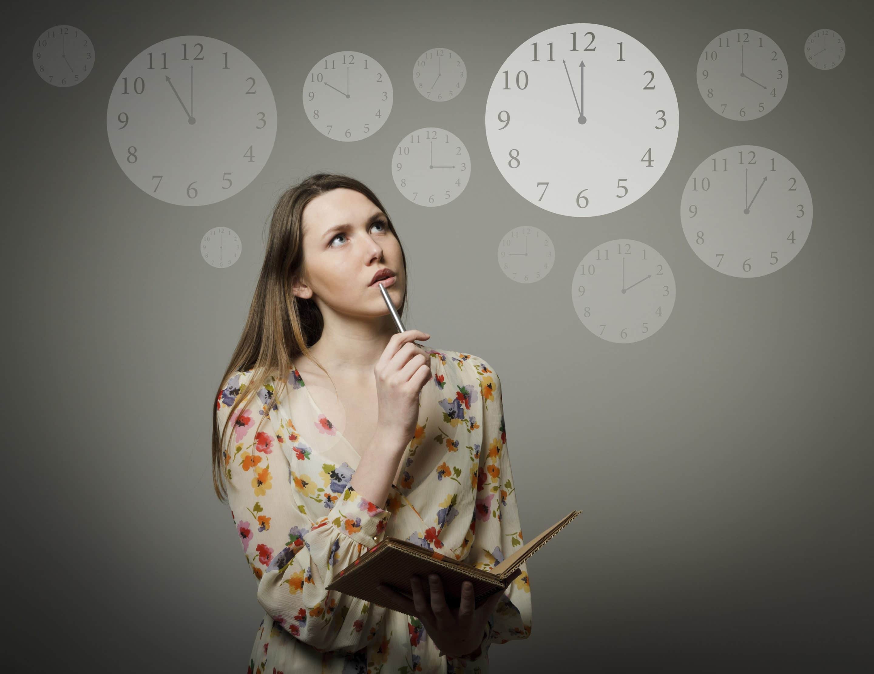 Thoughtful girl holding pen and notebook. Time concept.