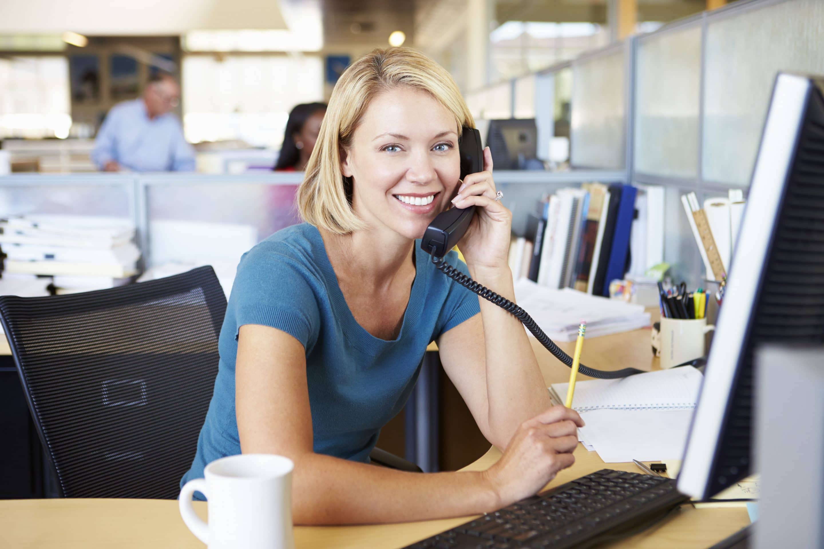 Woman On Phone In Busy Modern Office