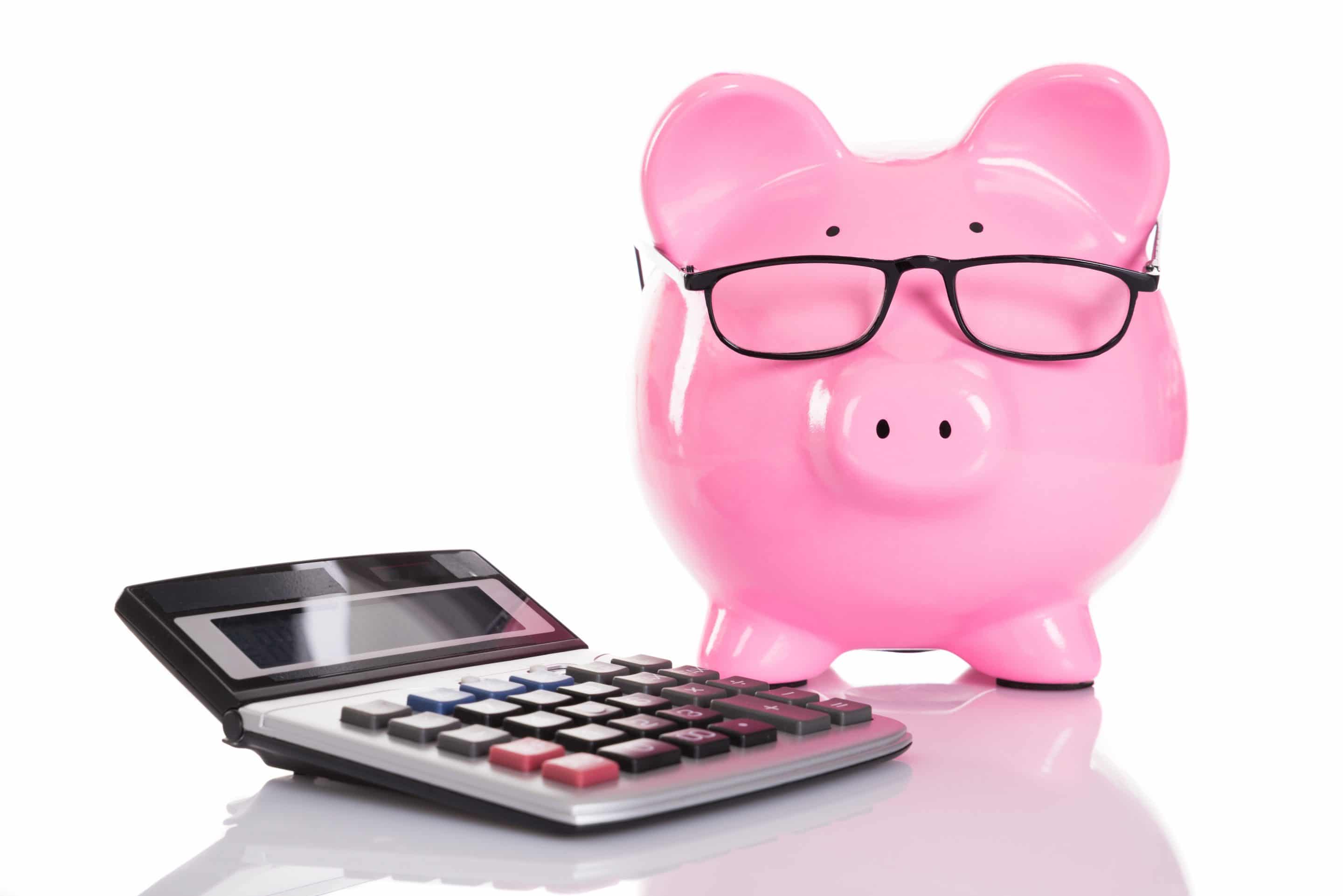 Piggybank and calculator. Isolated on white background