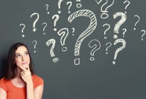 young girl with question mark on a gray background