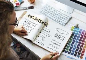 Woman looking a logo designs for branding on social media.