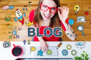 Blog concept with young woman wearing red glasses in her home office