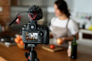 A scene of a woman cooking being filmed. 