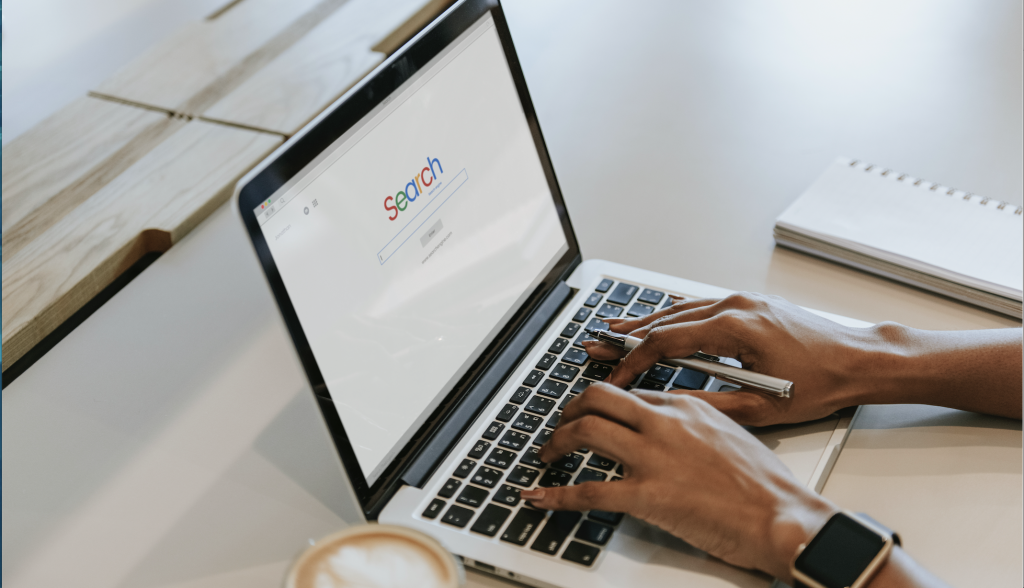 A person's hands conducts a search on a computer scree. This is to show that people will make decisions based off the first page of Google results. 