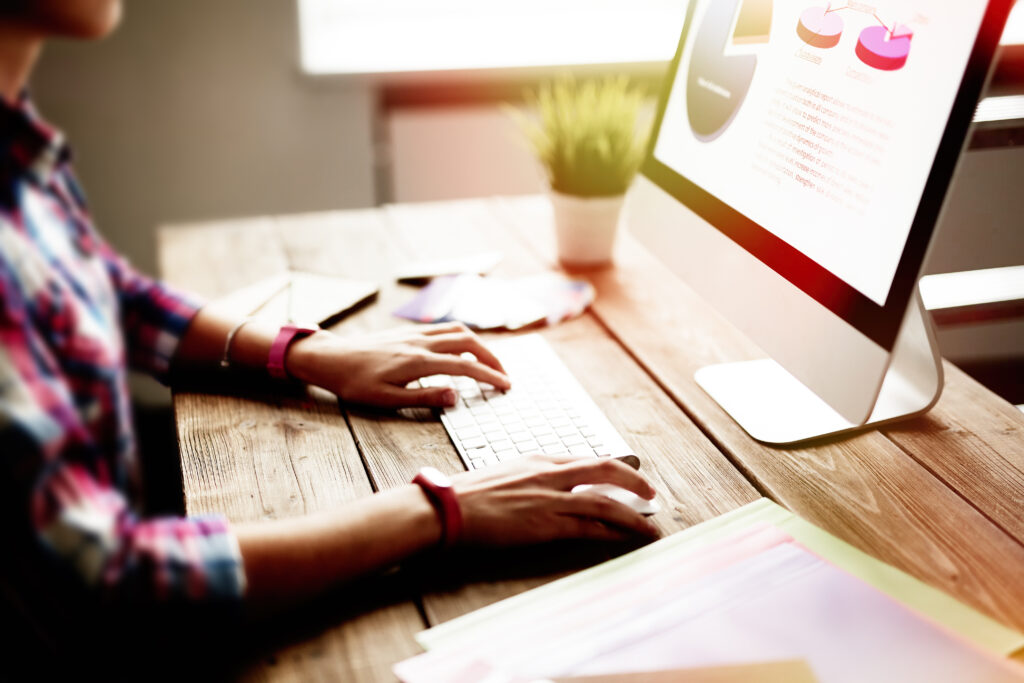 Young woman sitting in front of computer screen