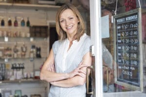 Small business owner standing in shop doorway