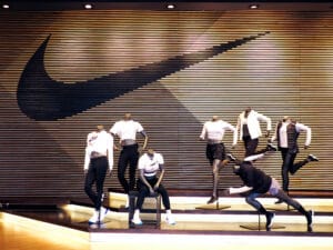 Nike storefront with clothing display and several mannequins demonstrates Nike's branding. 