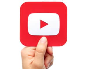 YouTube logo being held by someone's hand. 