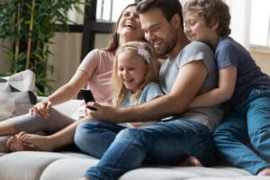 A family watches a video on their smart phone.