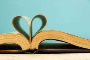a book laying open with the pages curved in a heart shape. 