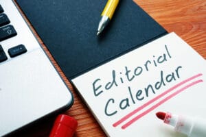 A public relations editorial calendar written on a notepad.