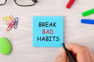 Post-it note saying "Break Bad Habits" on social media.