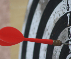 Dartboard with dart in bullseye