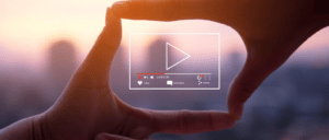 Youtube icon focused in the middle of two hands