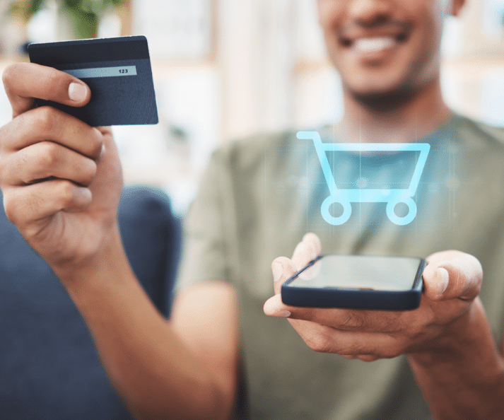 Online Shopping Man Holding Card and phone Boost Your E-Commerce Performance In Four Effective Steps