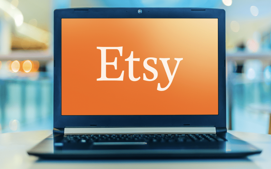 Etsy in white block letters on an orange screen on a laptop