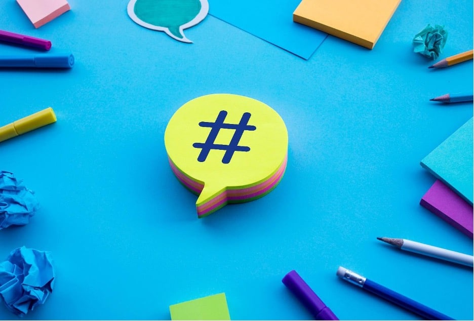 A hashtag symbol in a speaking bubble on a blue background.